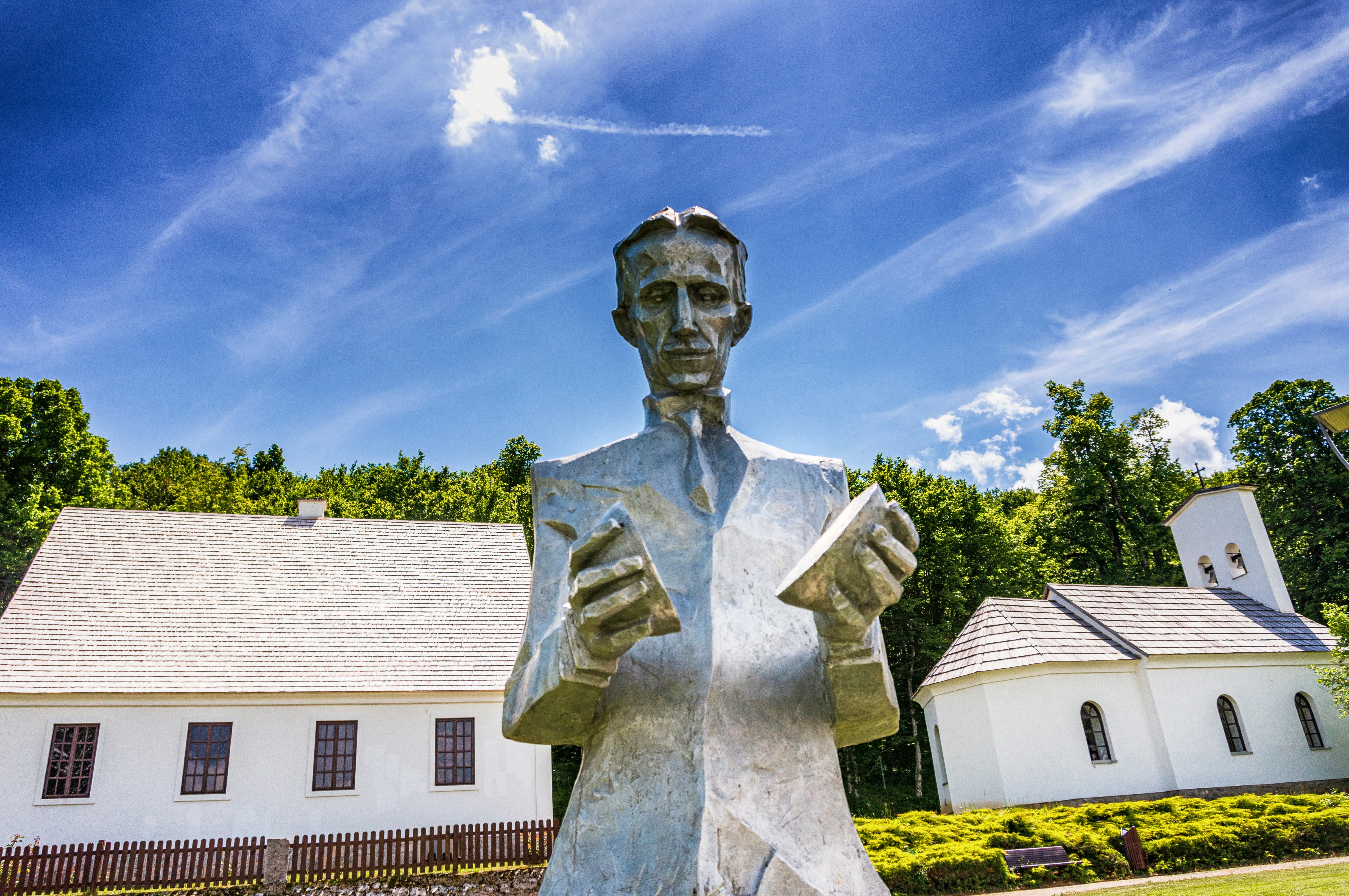 white concrete statue near white concrete building during daytime